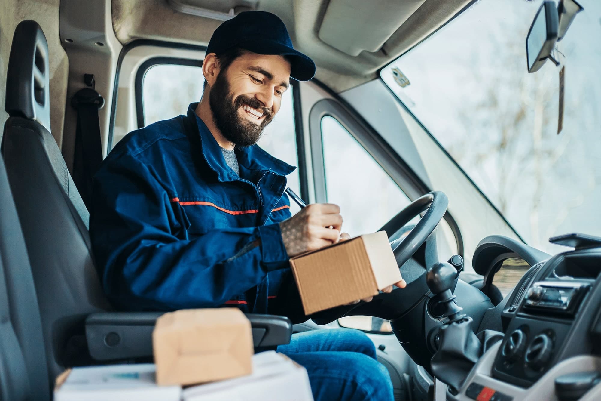 Delivery driver checking a package before the next stop